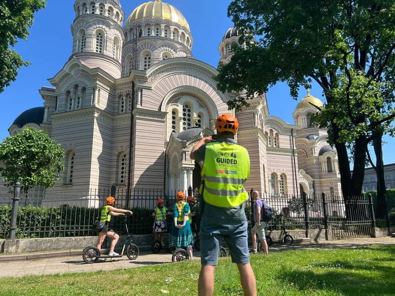 Riga Highlight Big wheel e-scooter Group or Private tour - Riding through Old Riga