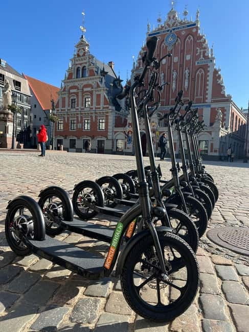 Riga Highlight Big wheel e-scooter Group or Private tour - Meeting at Rātes pasāža